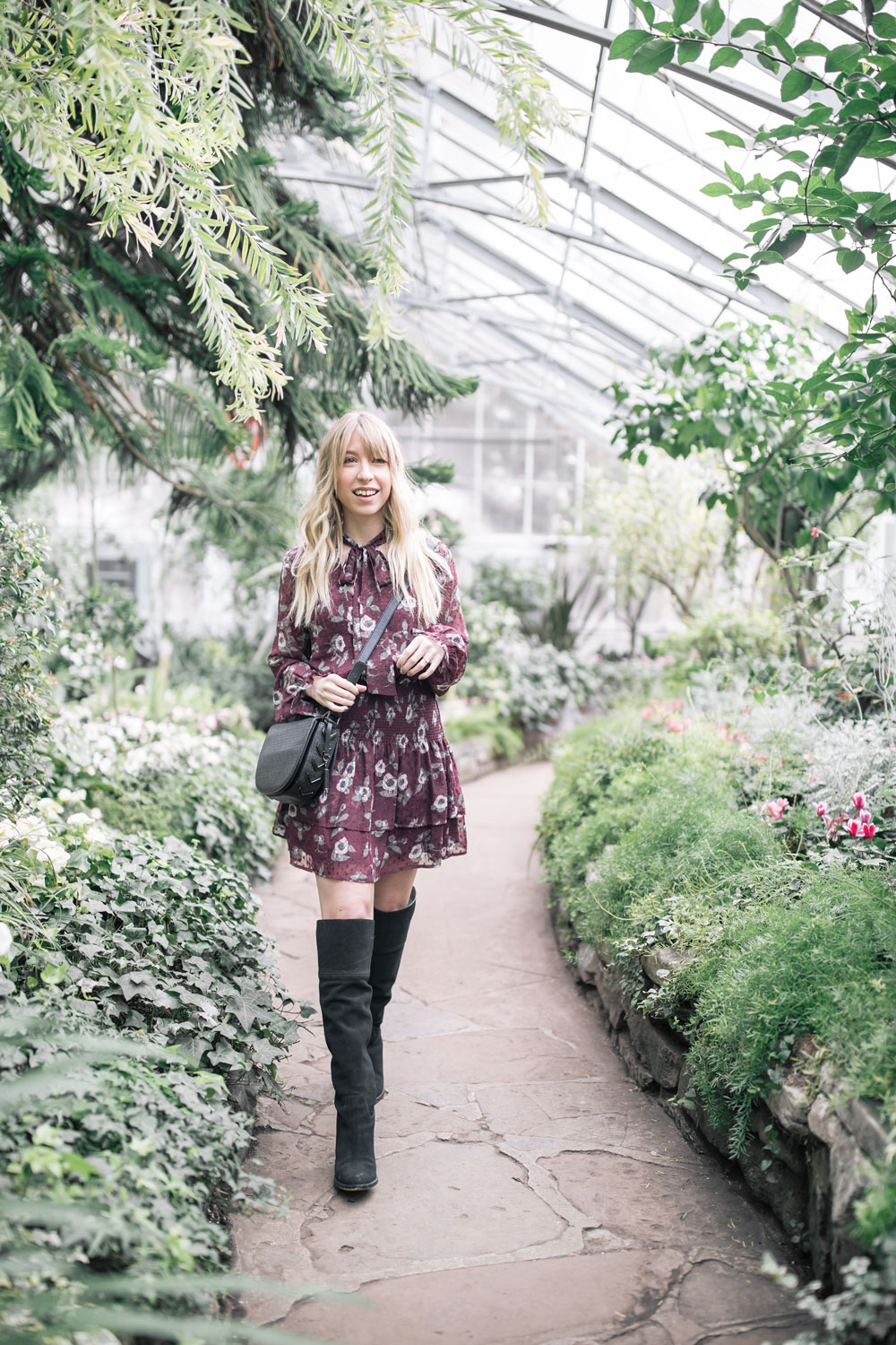 the blondielocks who is a toronto based lifestyle blogger is wearing a short smocked dress from nordstrom. moon river smocked dress. how to style over the knee boots.